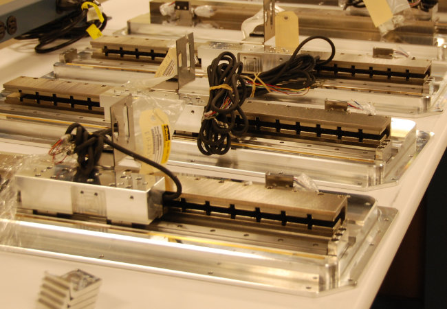 3 rows of mechatronic equipment in a facility.