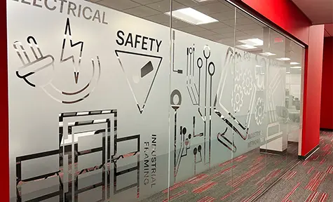Hallway looking into learning center through glass walls with Motion Automation icons on an opaque background