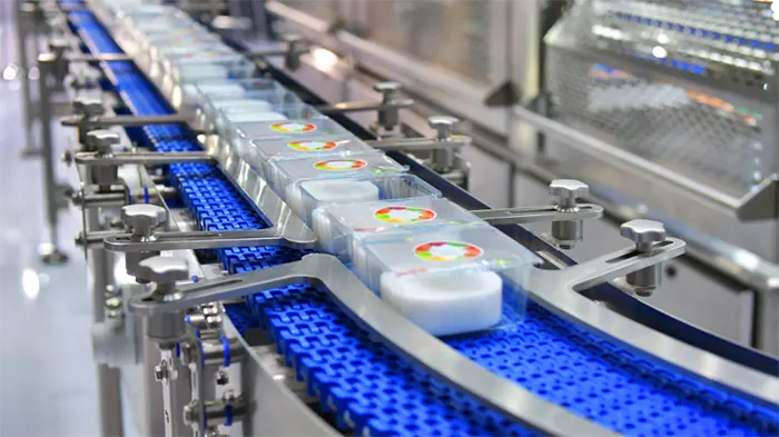 Packaged food product boxes transfer on automated conveyor systems