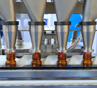Vaccine bottles standing on robotic production line