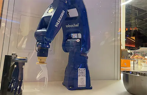Blue Yaskawa robotchef articulated robot arm on display in Bakery Kiosk