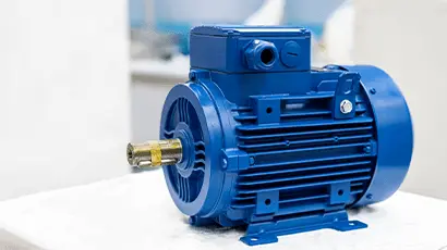 Close up of a new blue electric 3 phase induction motor for industrial use displayed on a table
