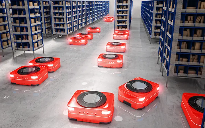 Small robots on the floor of a factory